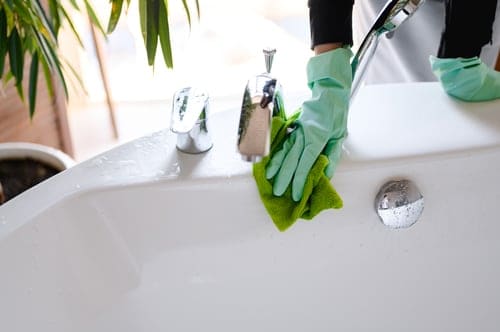 Strong Hands Cleaning technician cleaning a bright residential living room in Woodbridge, Virginia